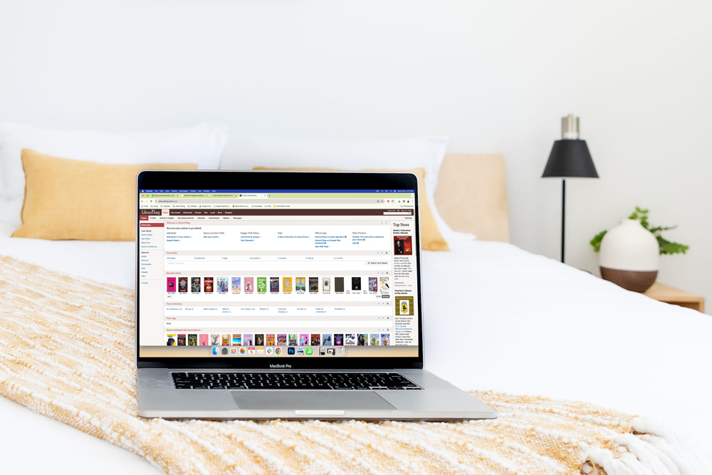 Laptop sitting on a bed with the LibraryThing website open.