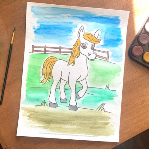 Horse coloring page painted white with golden mane and tail on a blue sky and green pasture background.