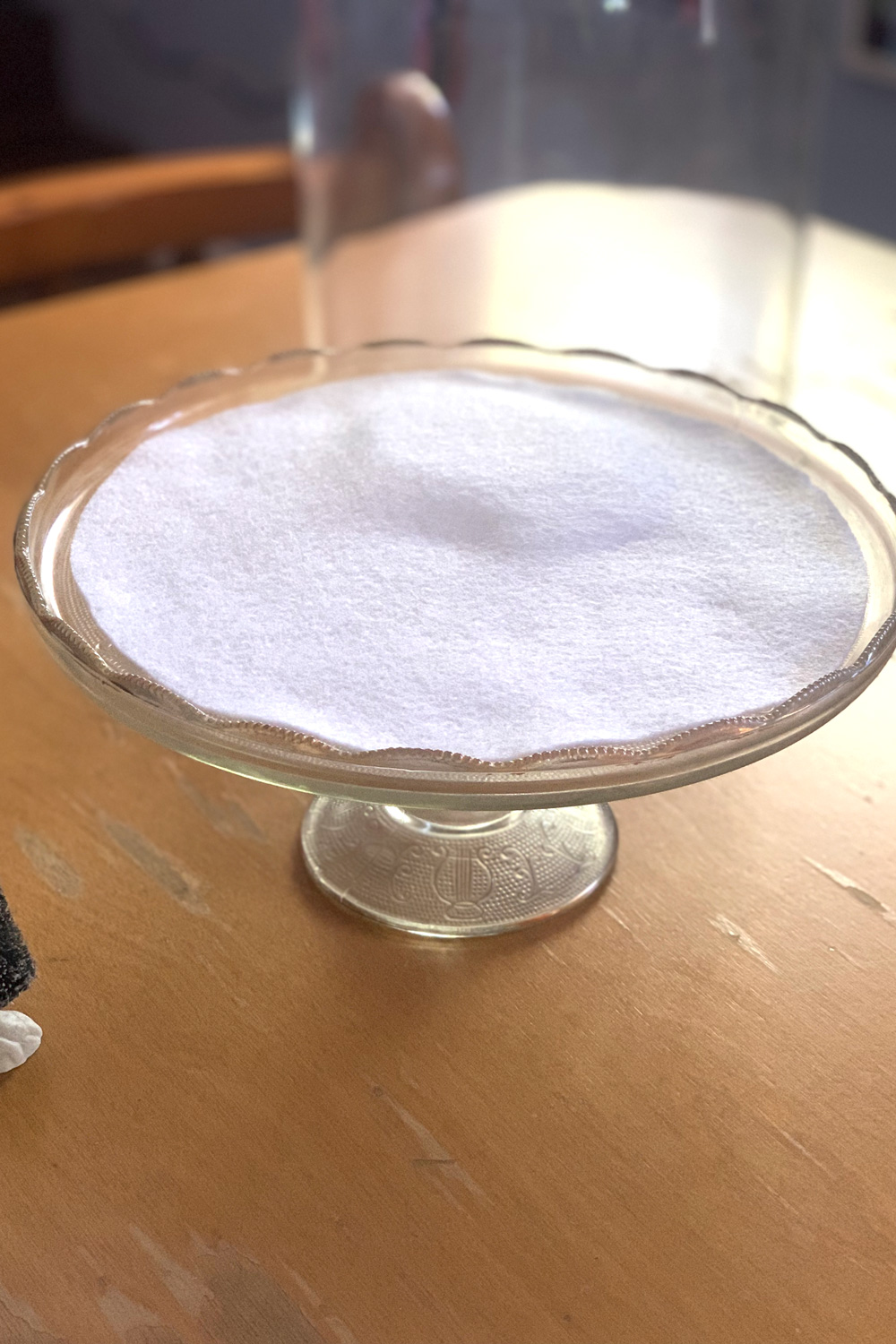 A large white felt circle covering smaller ones to create the illusion of a snowy hill.