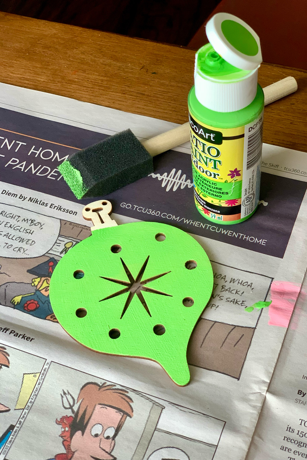 A wood ornament painted lime green.
