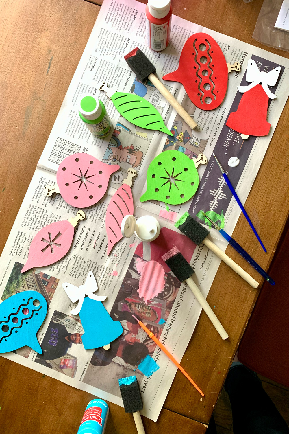 Wood ornament shapes painted red, pink, lime green, and teal blue.