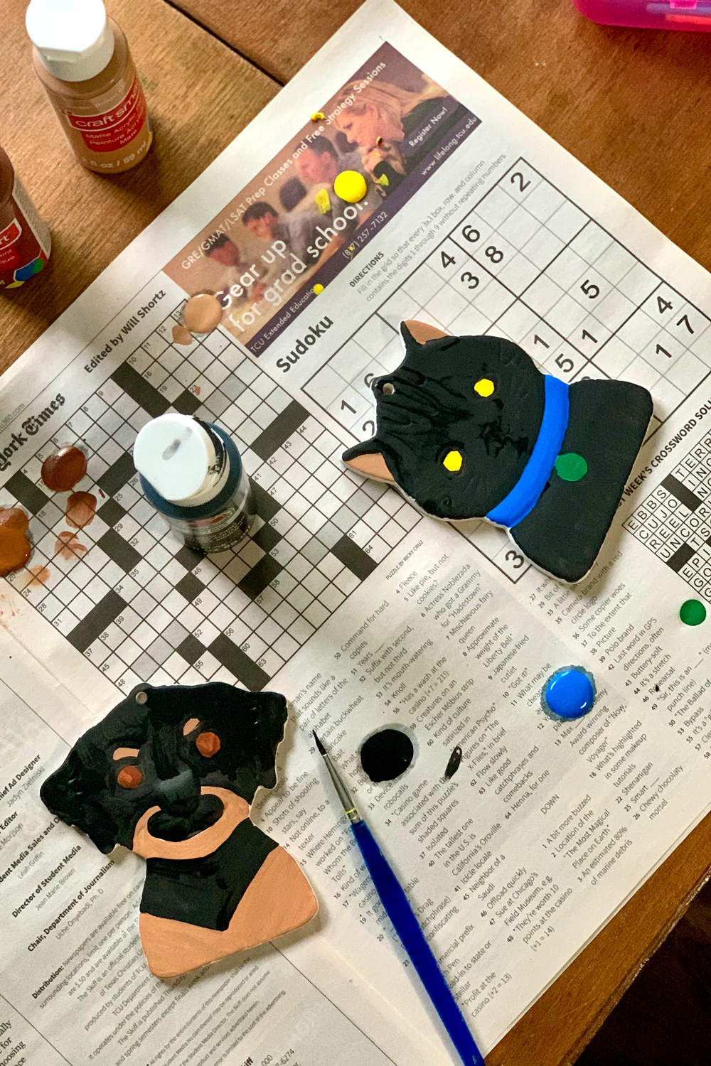 Dog and cat ornaments with larger sections painted black.