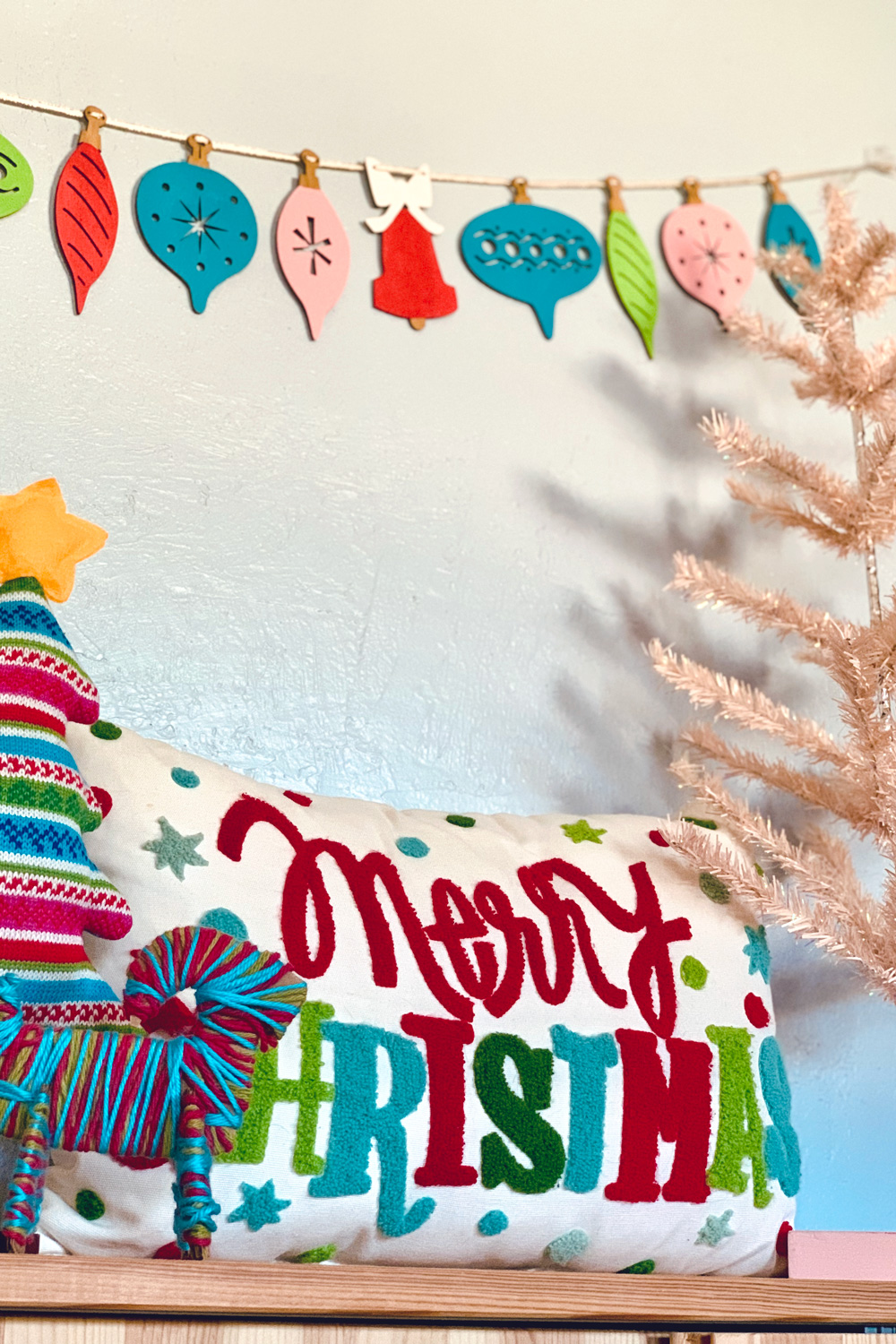 Retro wood ornament garland painted red, pink, lime green, and teal blue.