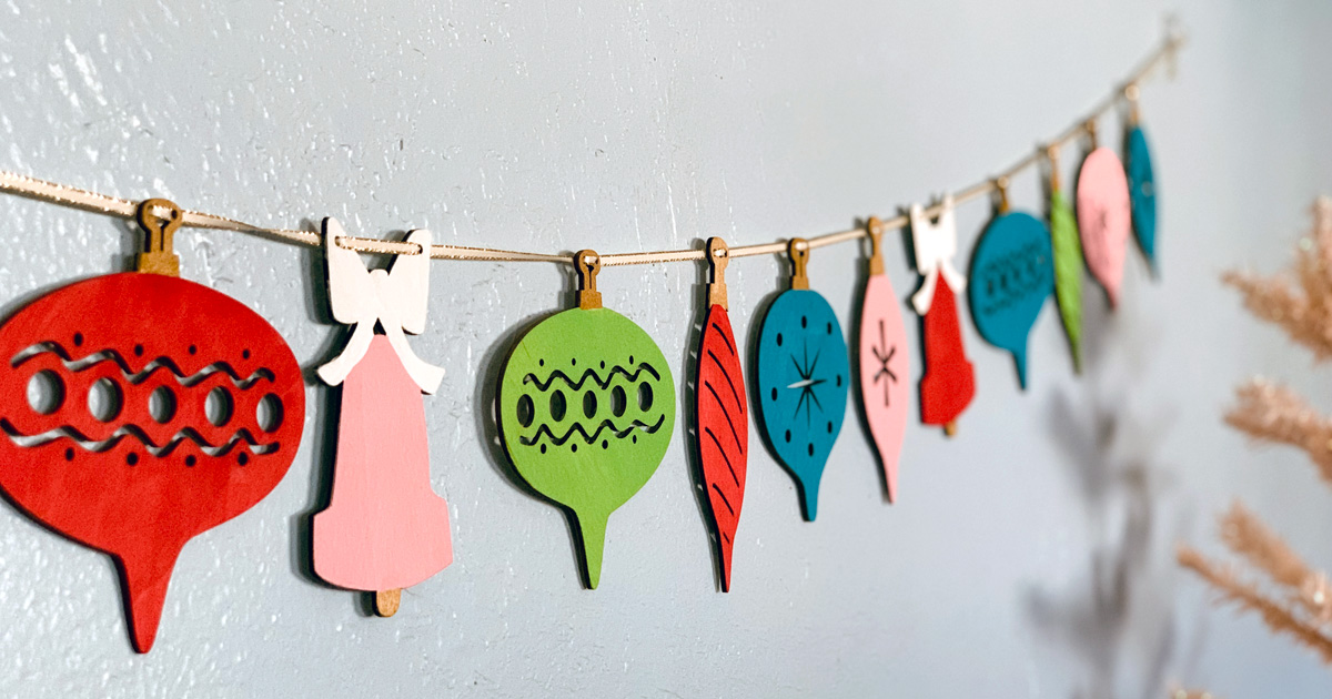 Retro wood ornament garland painted red, pink, lime green, and teal blue.