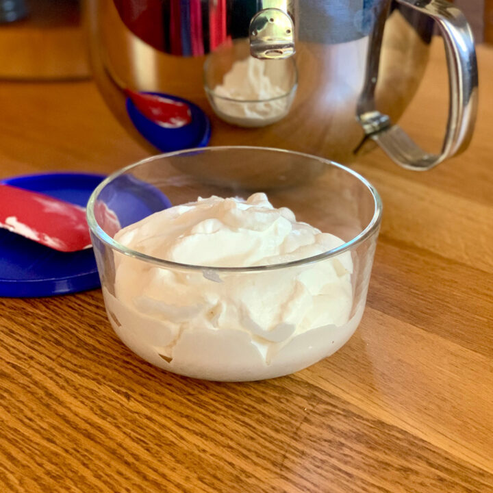 A glass dish of whipped cream.