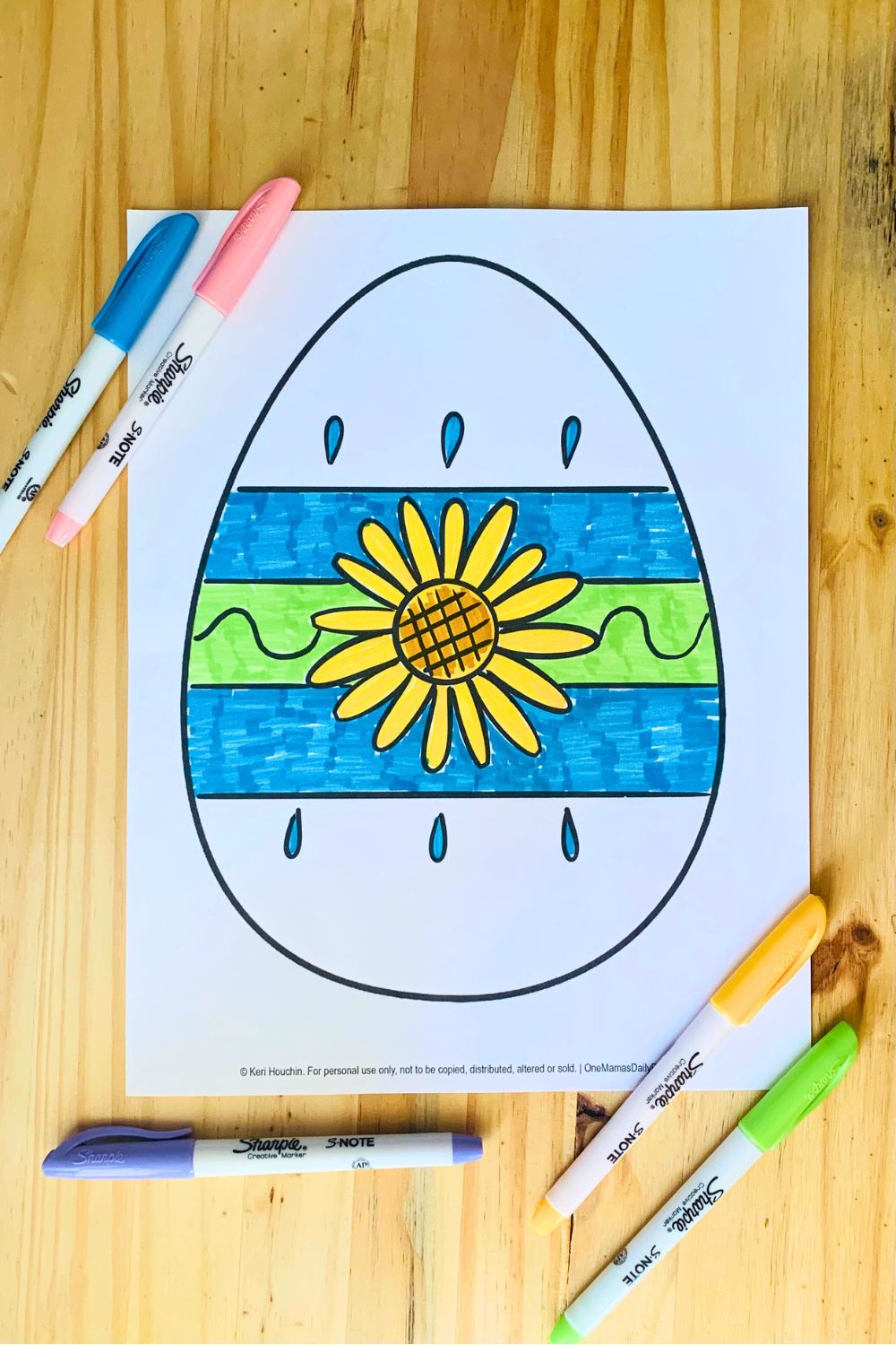 A egg drawing with a flower in the center and stripes.