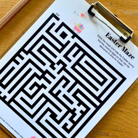 Printable Easter maze of a bunny pulling a wagon searching for painted eggs.