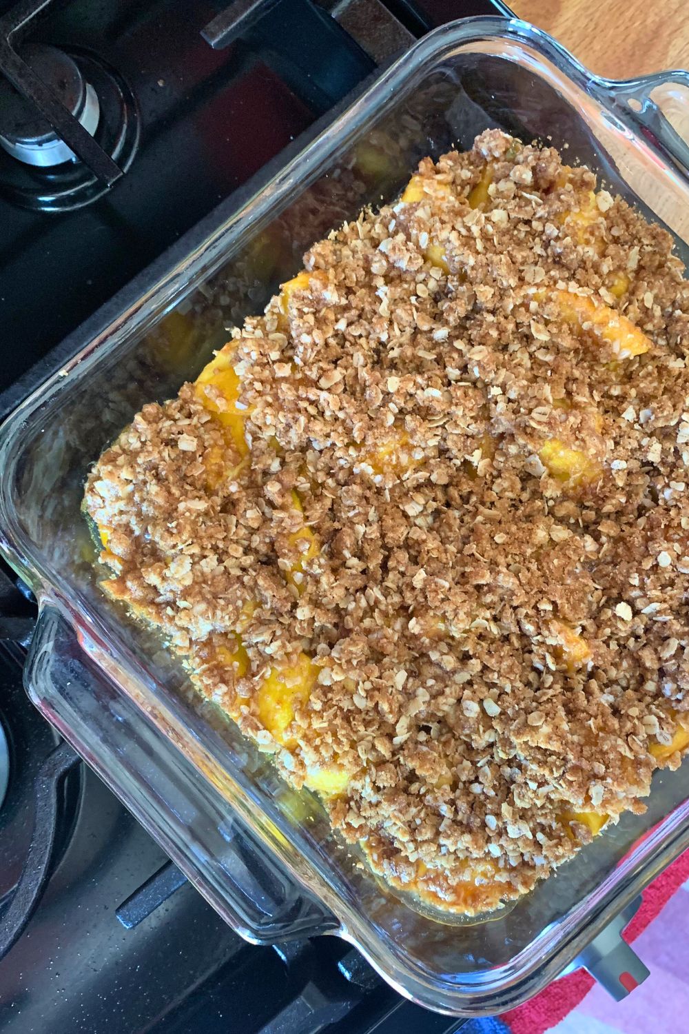 A baking dish of hot peach crisp right out of the oven.
