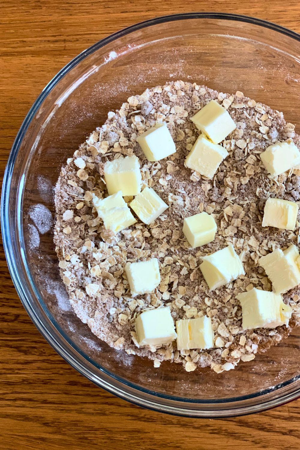 Dry ingredients mixed with butter cubes on top.