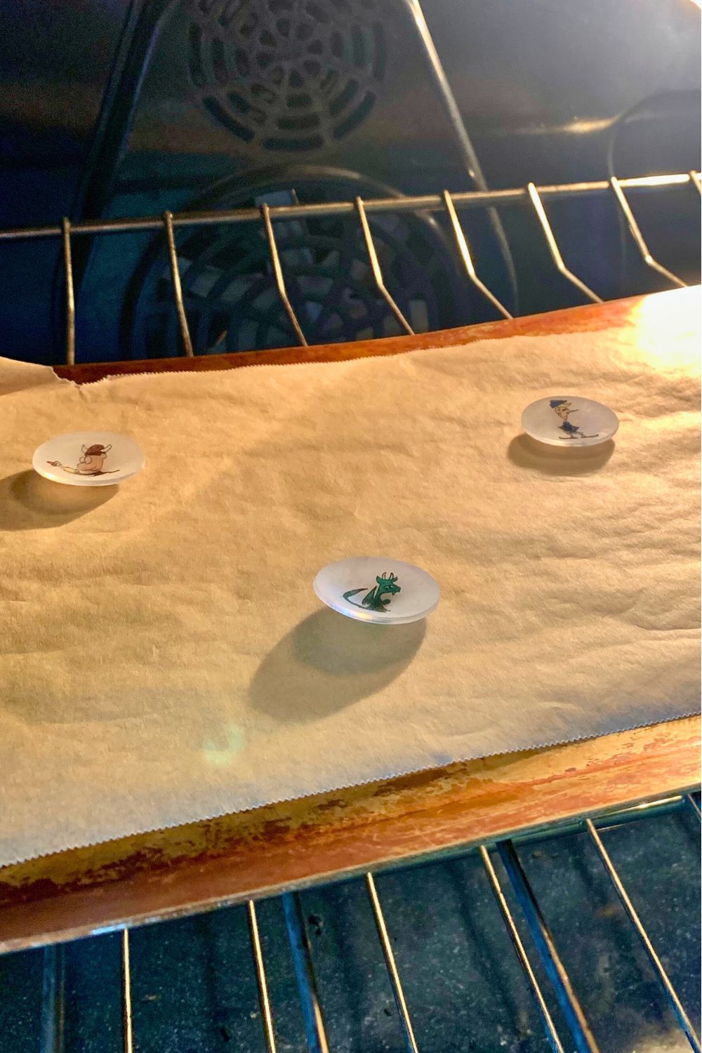 Shrinky Dinks in the oven warped and almost finished baking.