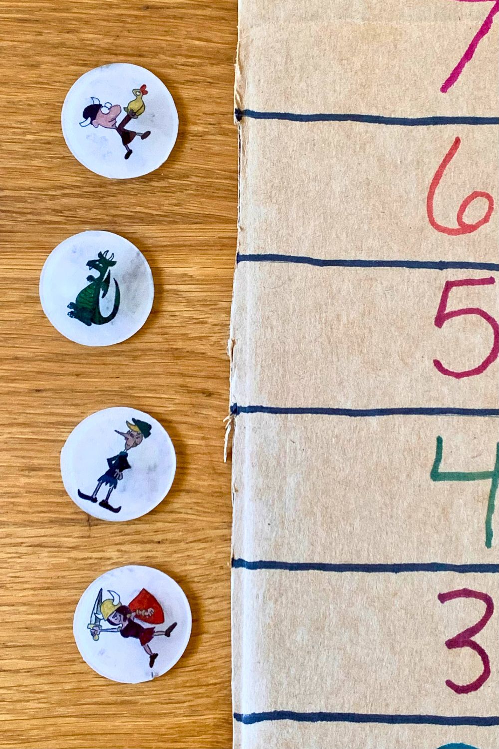 A game level tracker beside 4 Shrinky Dink tokens featuring a boy with a duck, a dragon, and elf, and a warrior girl with a sword.