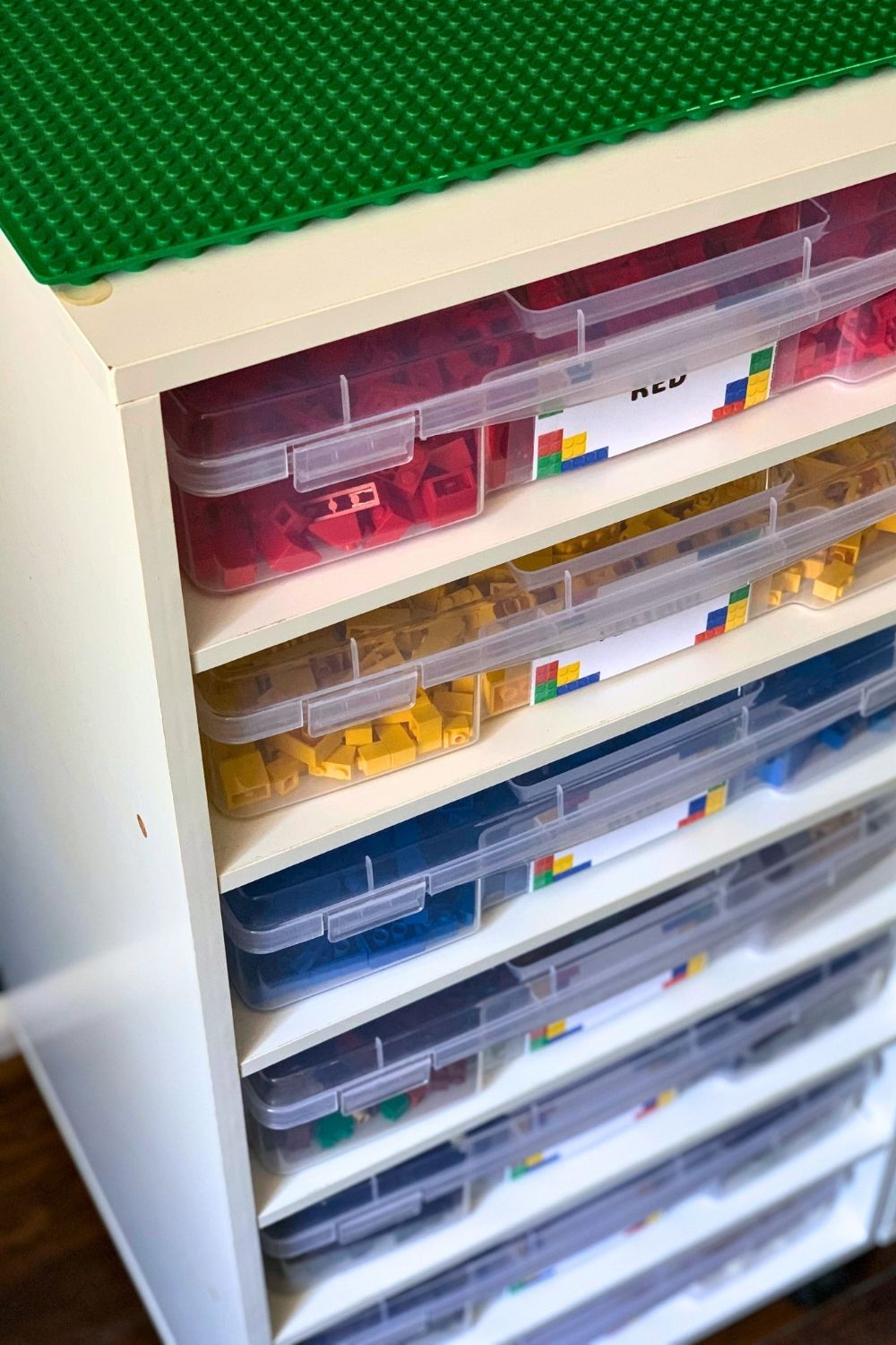LEGO bricks sorted into clear boxes by color.