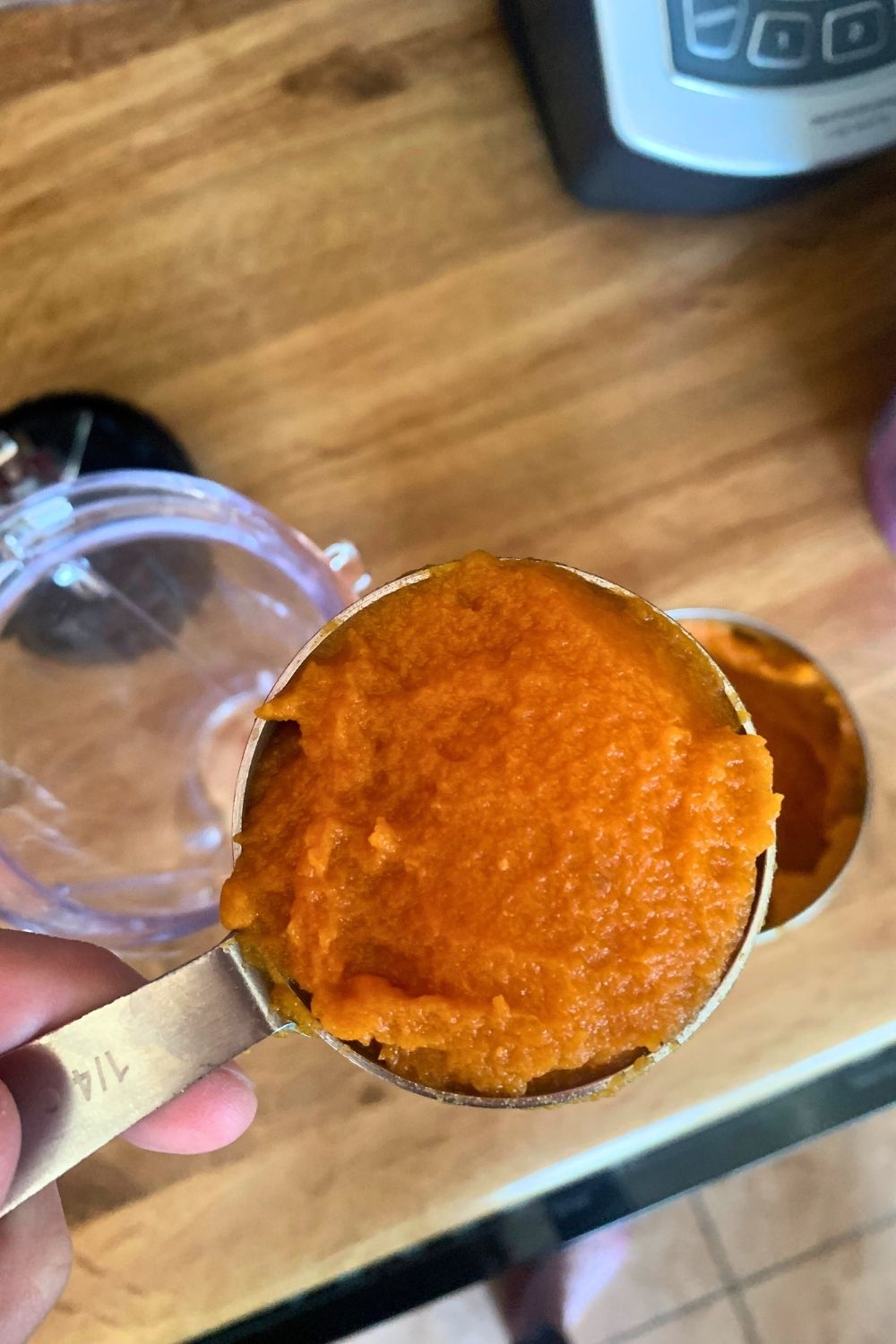 A quarter-cup scoop of pumpkin puree.
