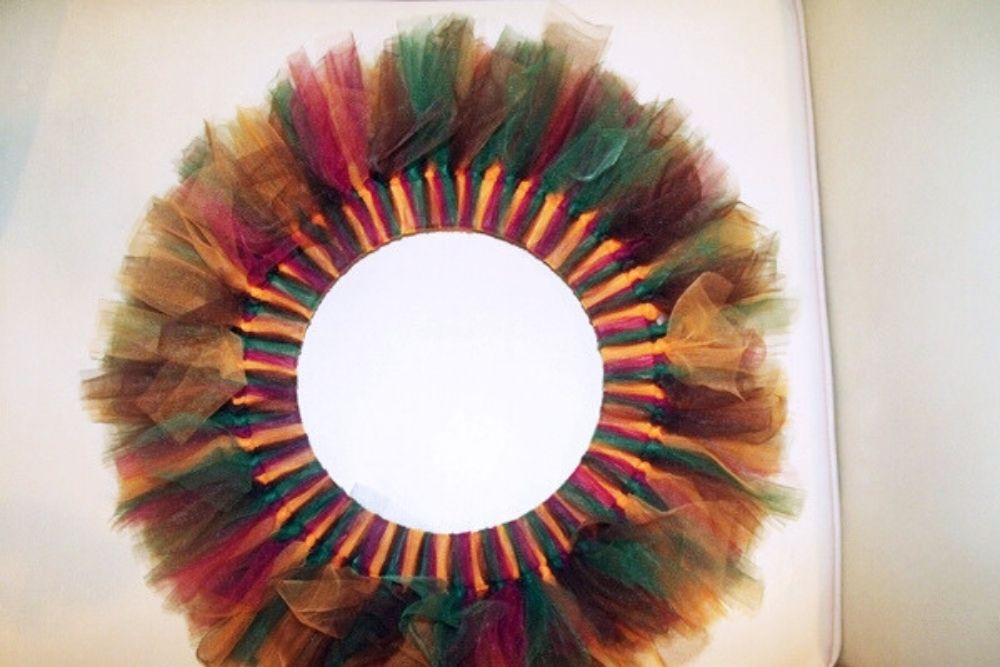 A wreath filled with fluffy jewel-toned tulle.