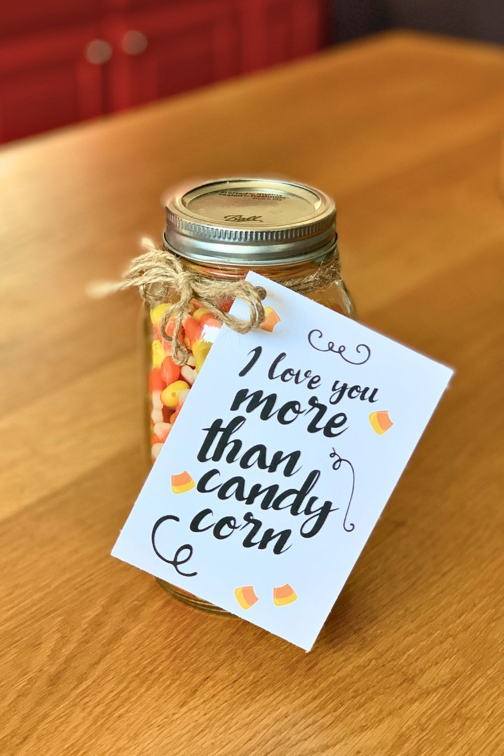 Class jar of candy corn with a Halloween card that reads "I love you more than candy corn."
