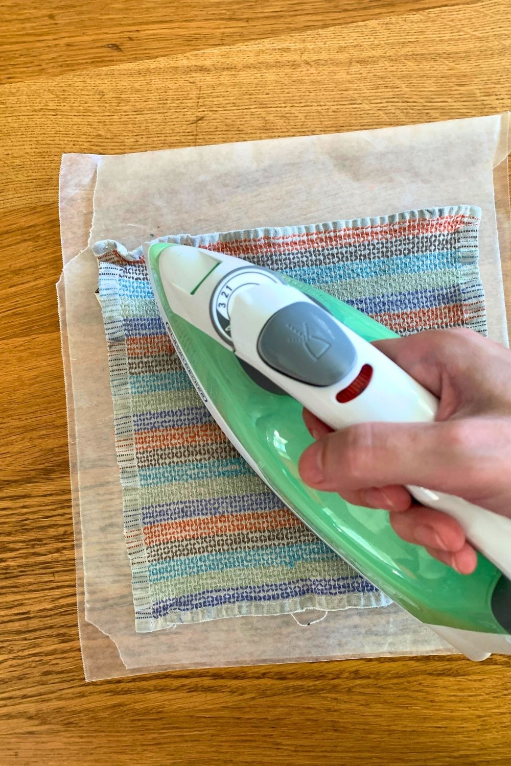 Ironing a towel on top of the wax paper and crayon shavings.
