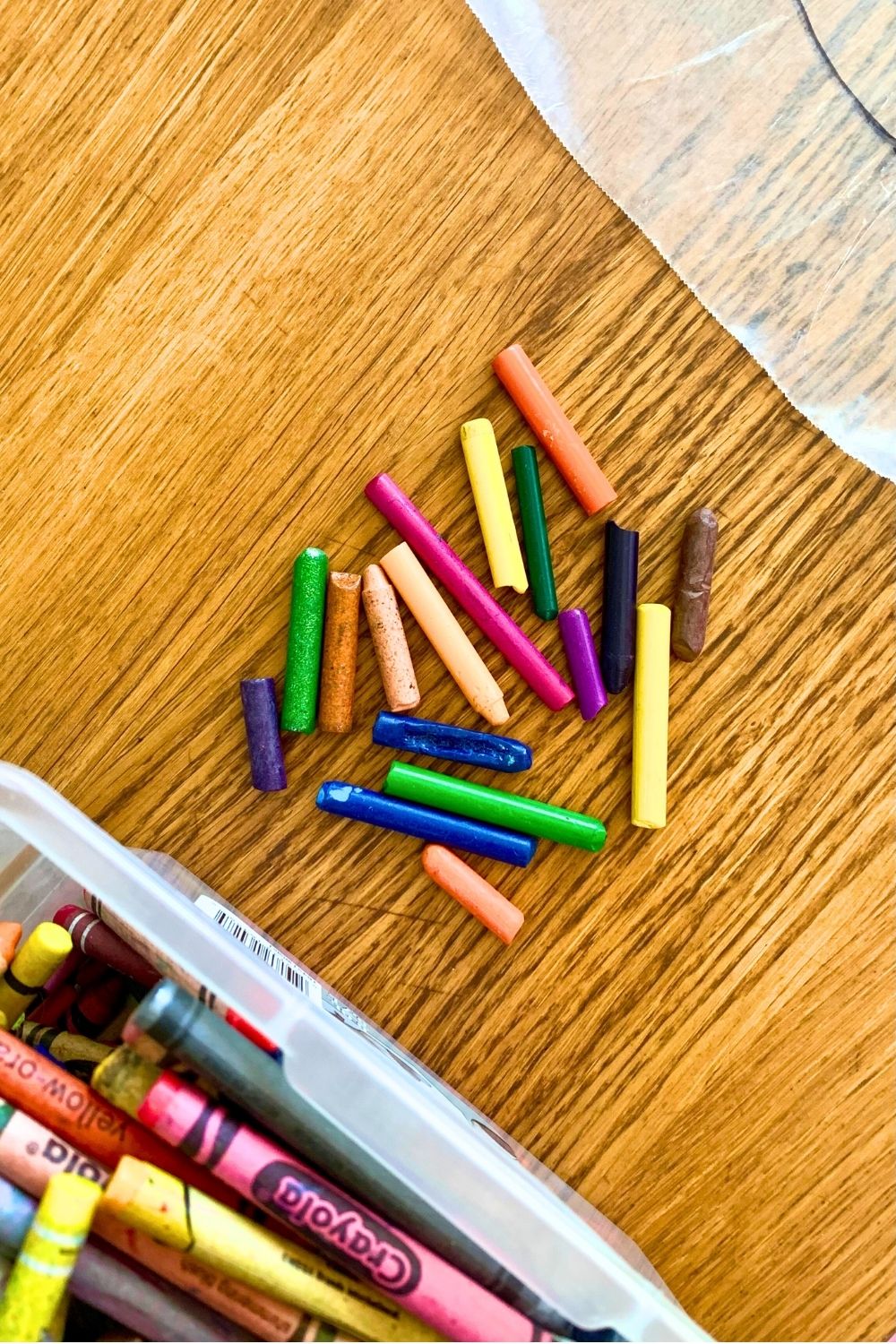 A pile of crayon pieces in various colors with the paper removed.
