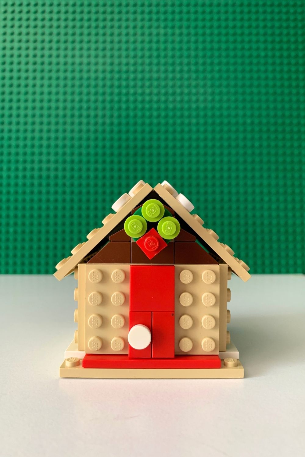 Smooth red pieces make a door on a wall.