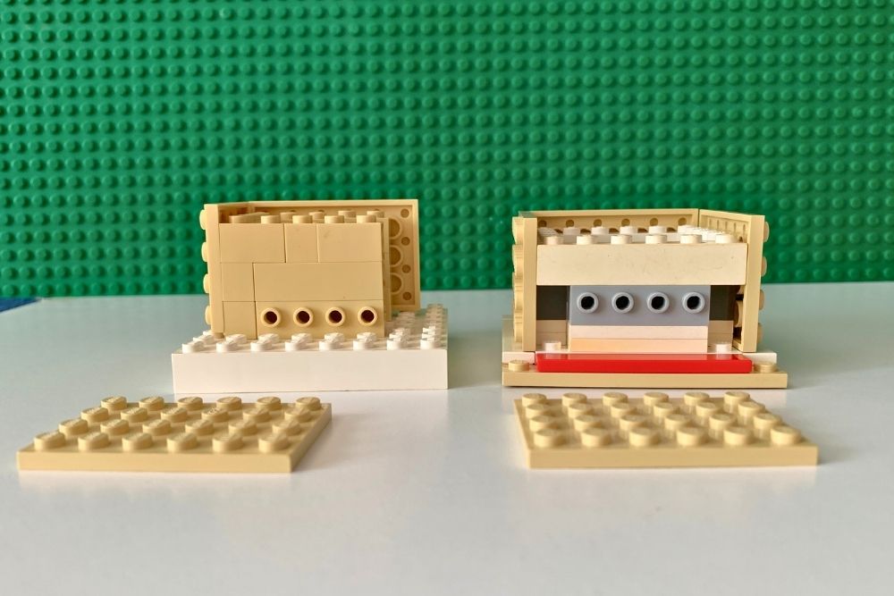 Two sets of walls build on a square base plate using tan bricks with side studs to hold additional baseplates as walls.