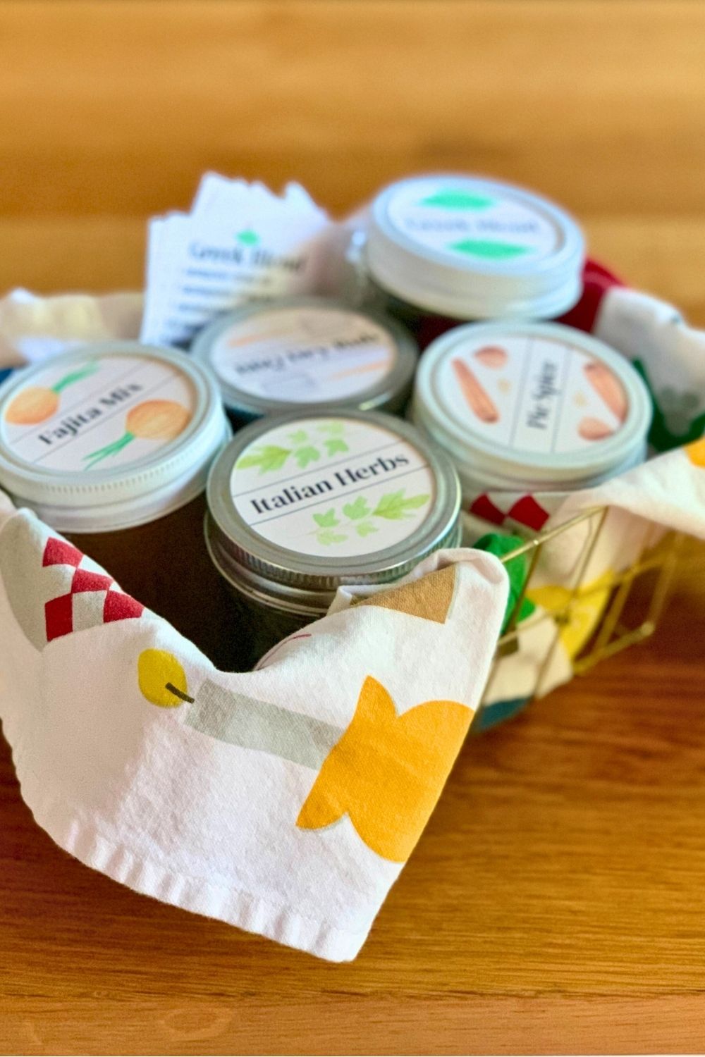 Spice blend gift basket of 5 small jars and ingredient lists.