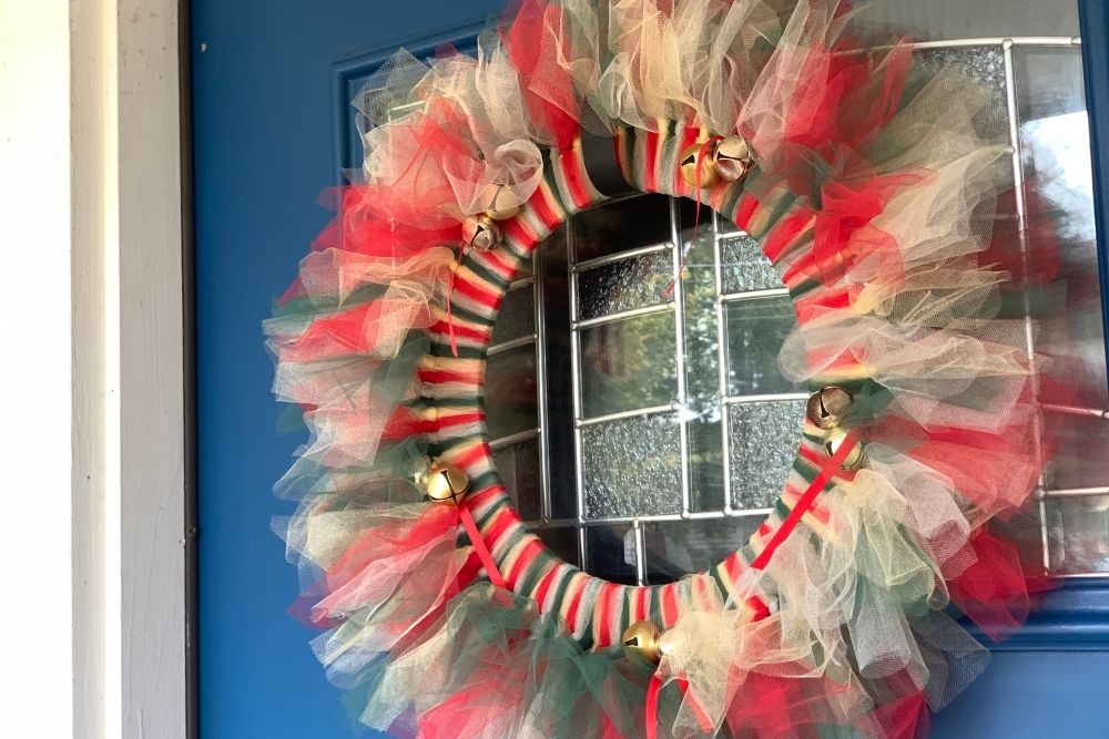 Closeup of a tulle Christmas wreath in traditional red and green.