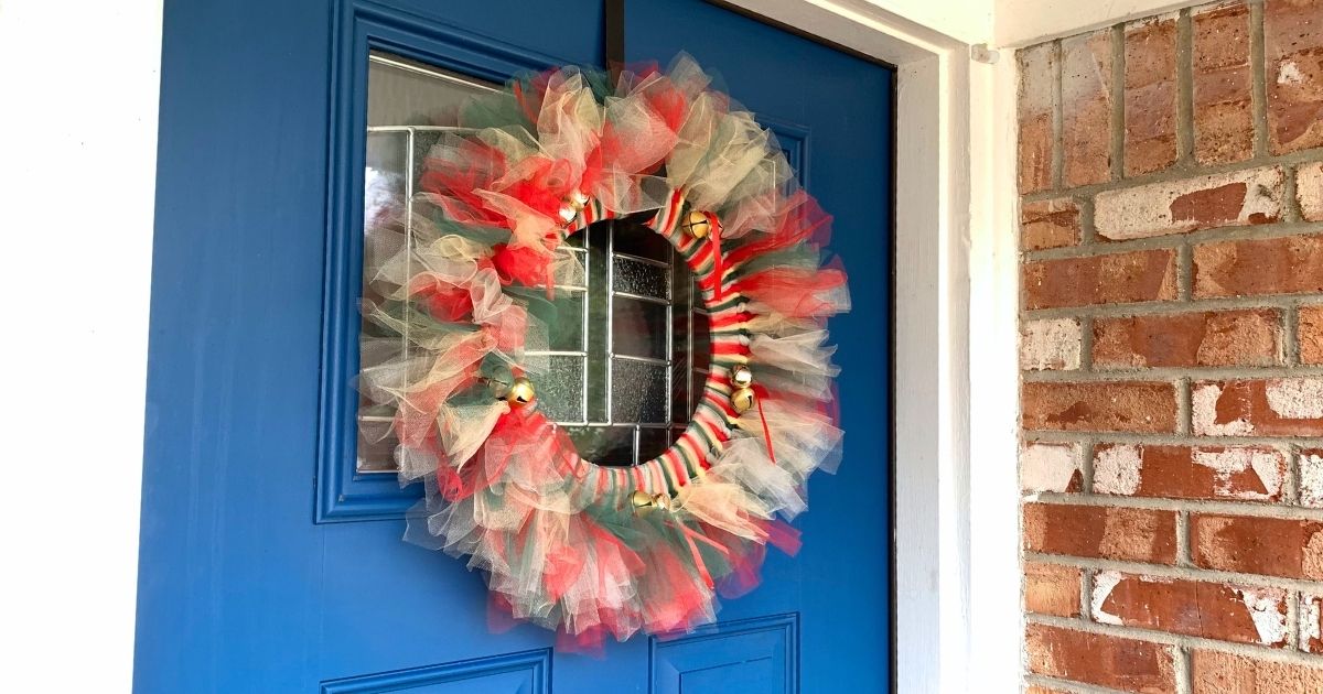Red, gold, green, and silver tulle Christmas wreath with jingle bells.