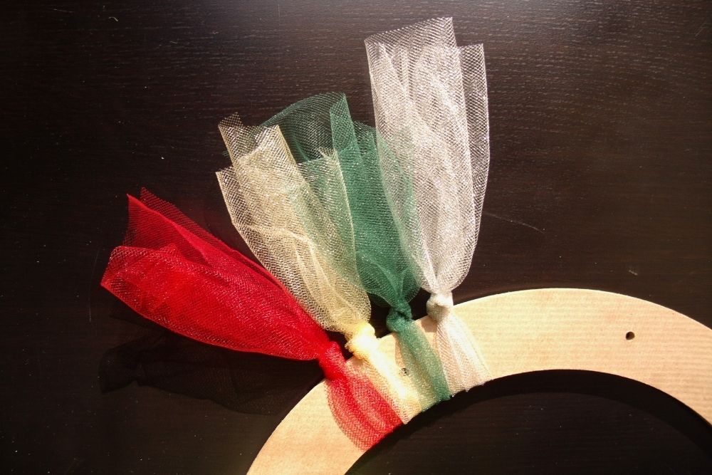 Knotted tulle in red, gold, green, and silver.