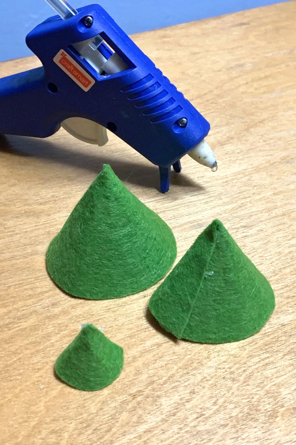 Three green felt half-circles folded into cones.