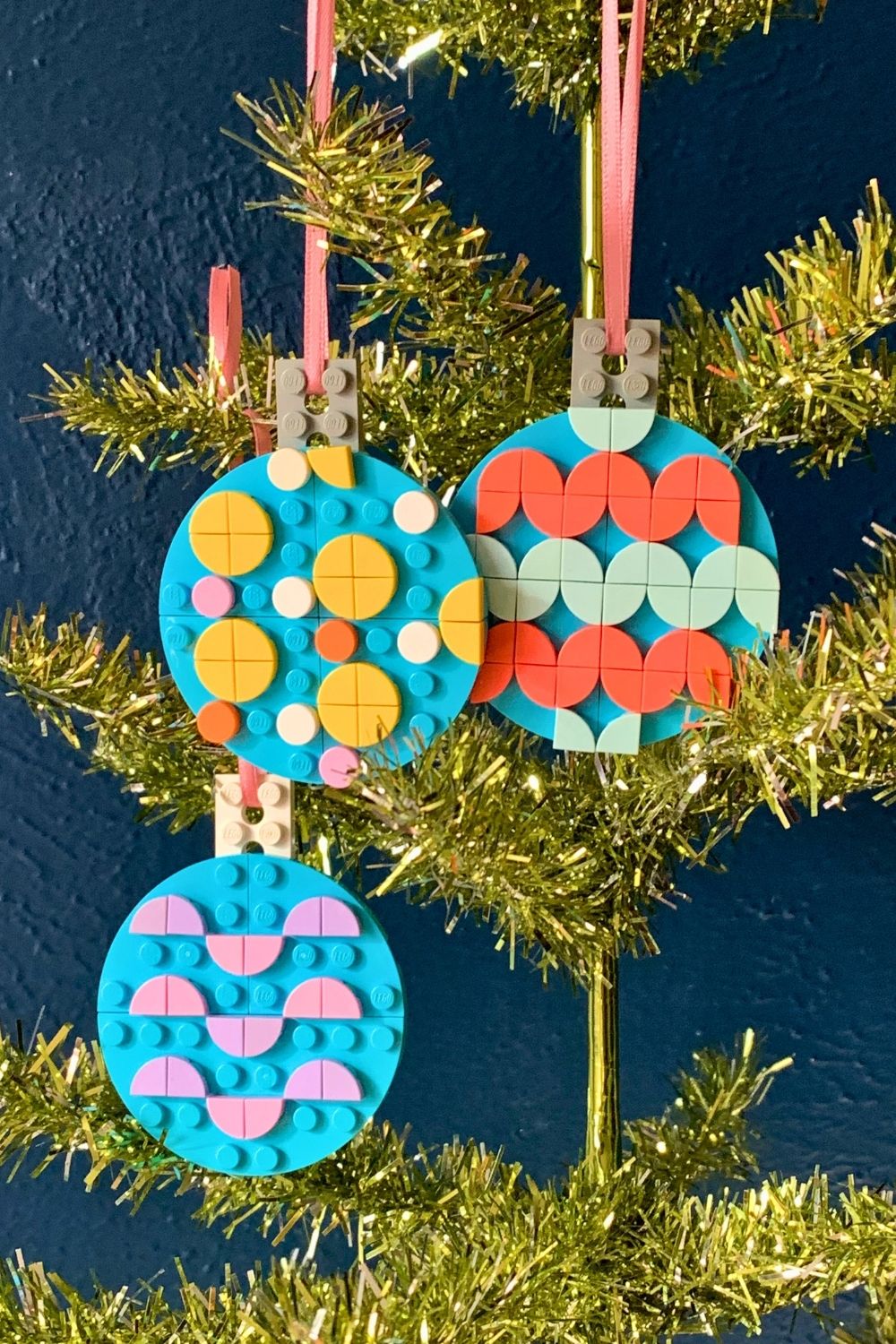 Three flat LEGO ball ornaments decorated with colorful dots in patterns.