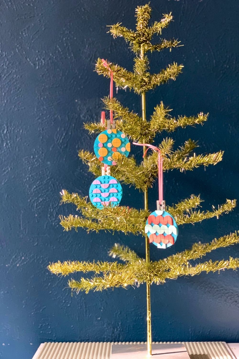A mini Christmas tree decorated with LEGO ornaments.