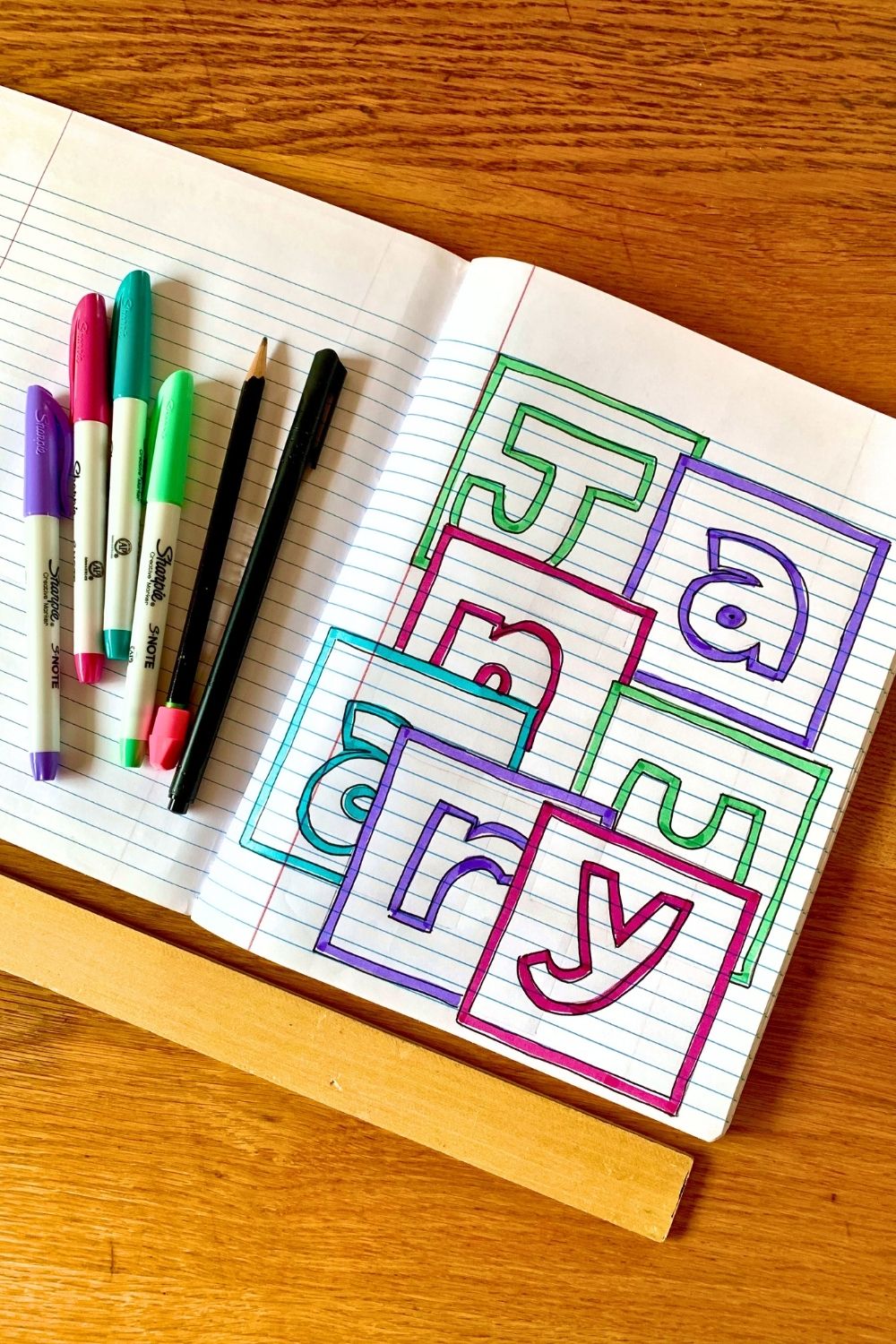 Lined notebook page with each letter of January in an overlapping box, colored in purple and green markers.