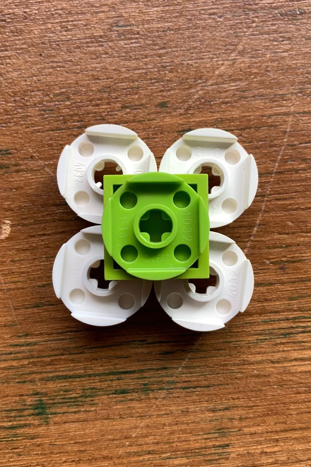 A green circle attached to the backside of a green square.
