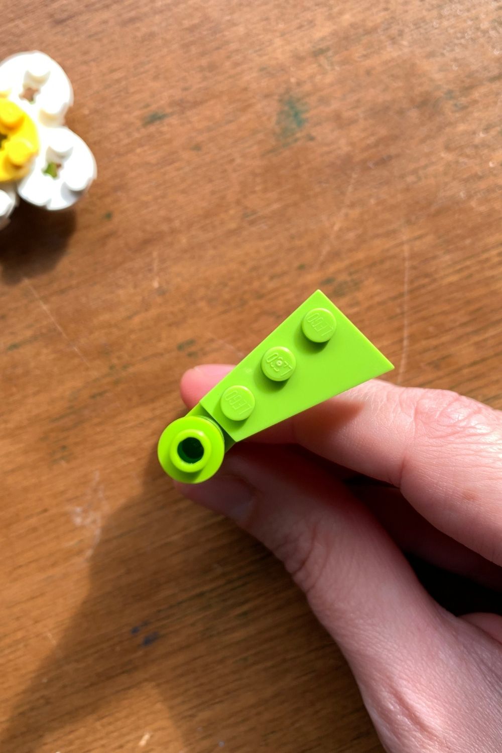 A triangular green plate attached to the slope.