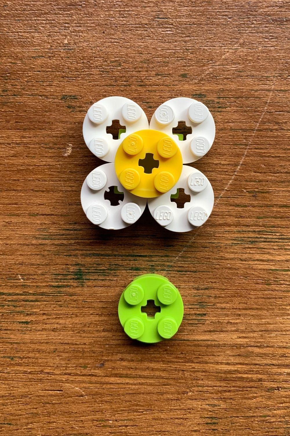 A yellow circle centered on top of 4 white circles with a green circle beside them.