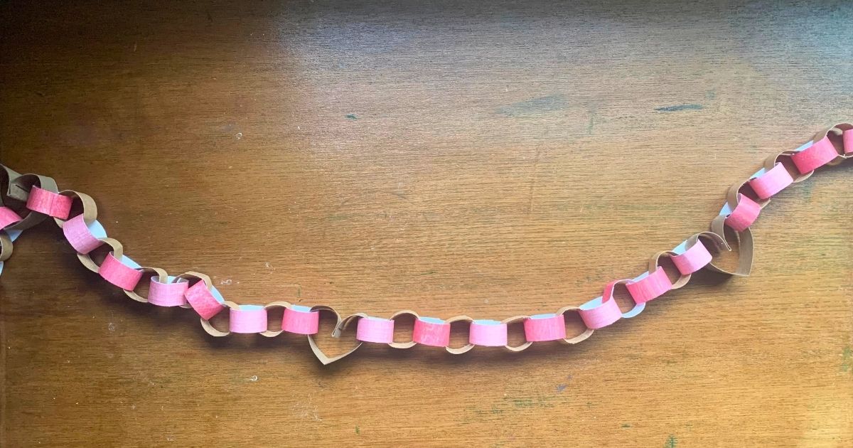 Valentine's Day garland made from paper tube hearts and pink paper chains.