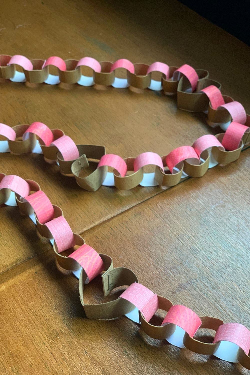 Valentine's Day garland made from paper tube hearts and pink paper chains.