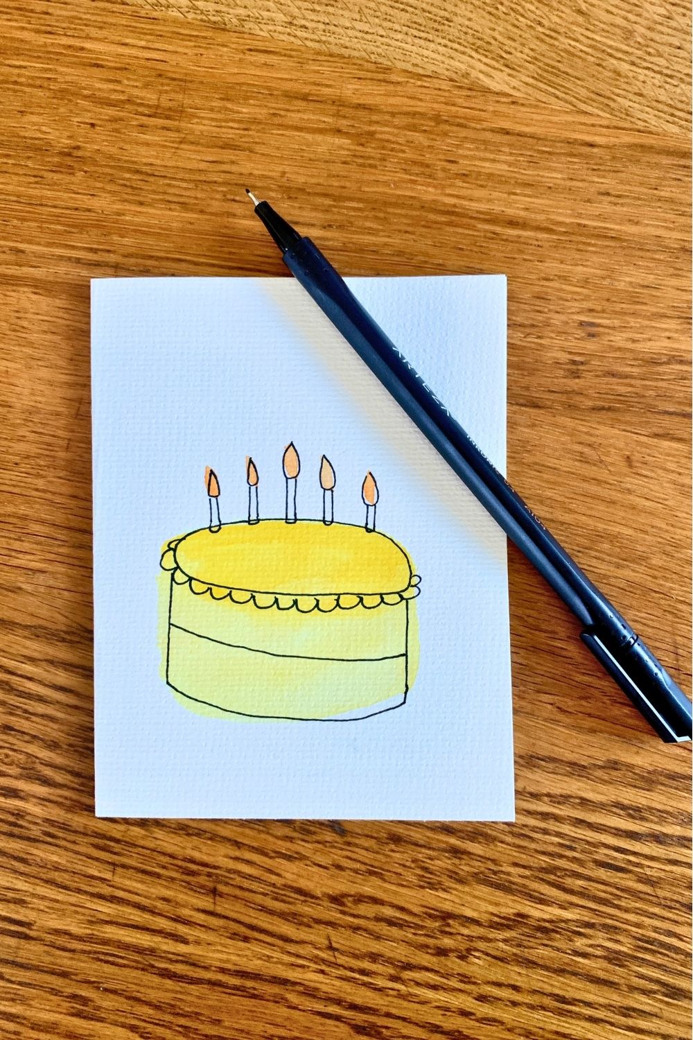 Outlining a cylinder to resemble a cake with tiny birthday candles.