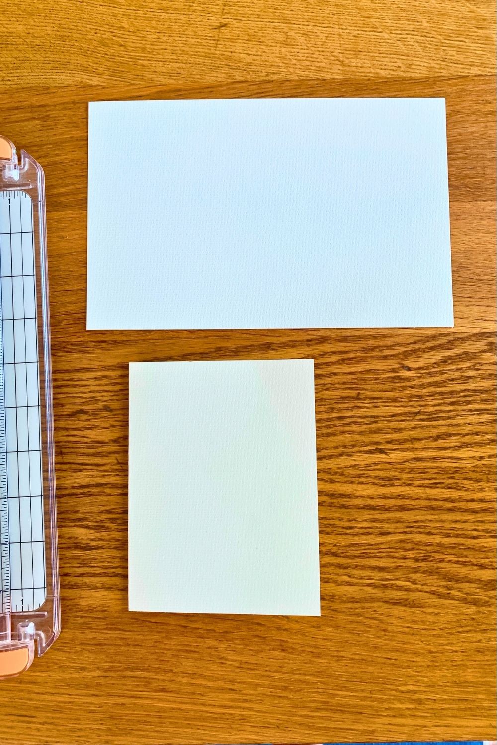 White watercolor paper cut in half and folded.
