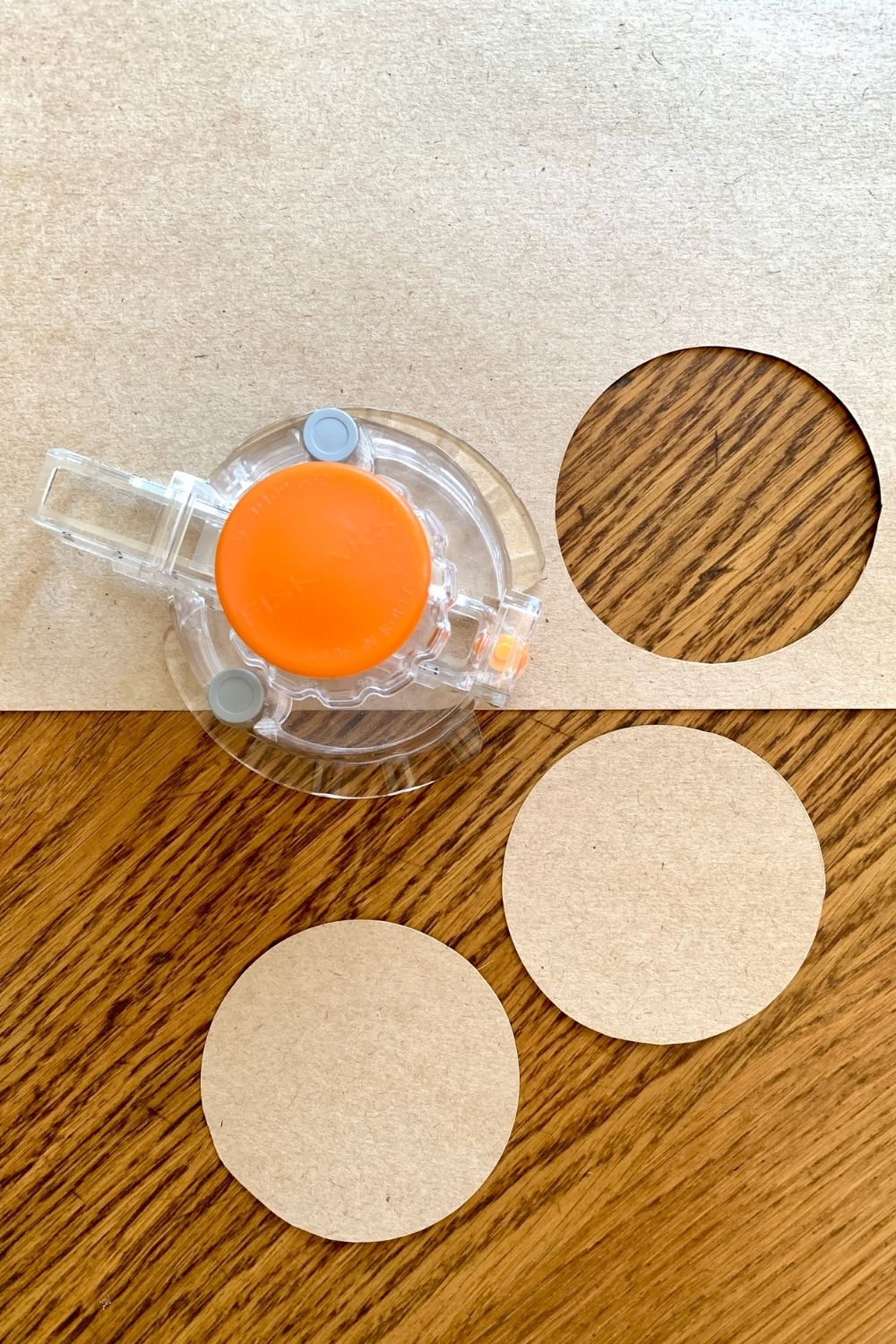 A circle cutter and 2 kraft paper circles.