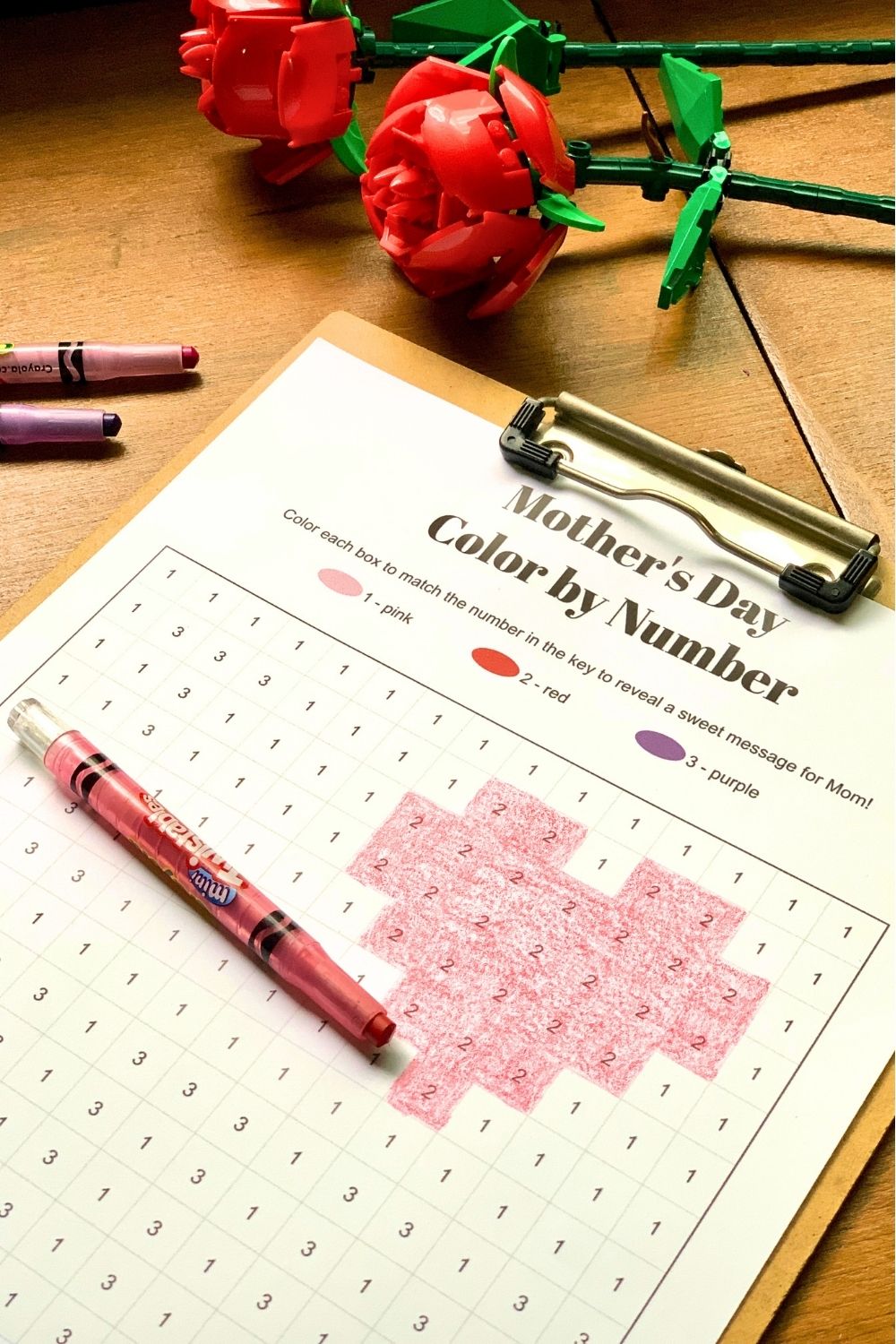 A red crayon beside a colored heart on the printable worksheet.