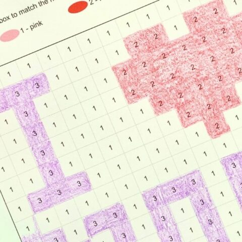Closeup of a Mother's Day color by number printable with numbered boxes colored purple and red to show I heart mom.