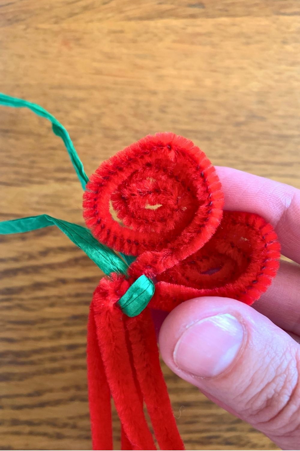 Twisting each red stem into a spiral.