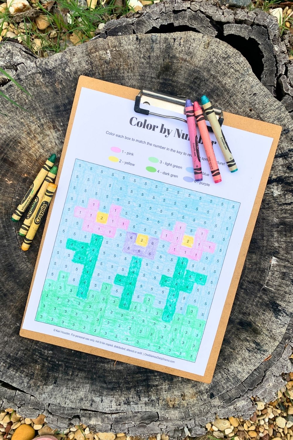 Printable spring color by number with a pixel grid and 3 pink and purple flowers with green leaves.