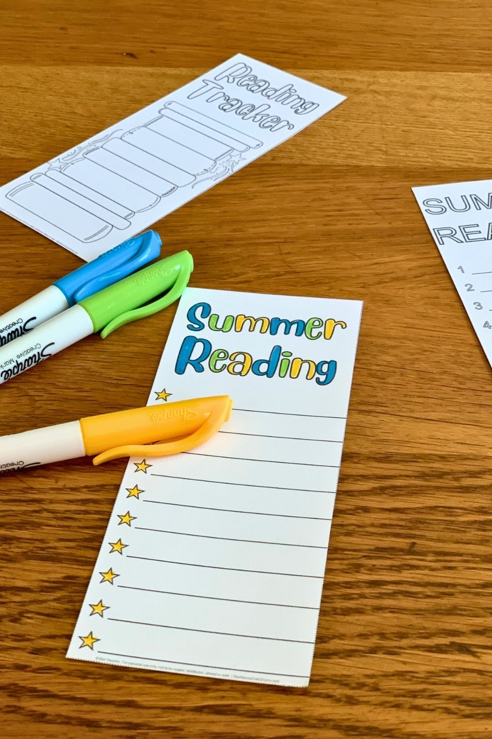 Summer reading bookmark colored blue, yellow, and green with stars for a bullet point list.