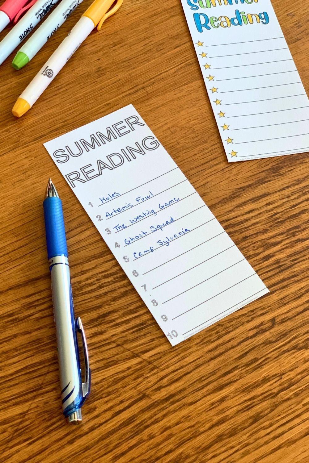 Bookmark reading list with titles written on numbered lines.
