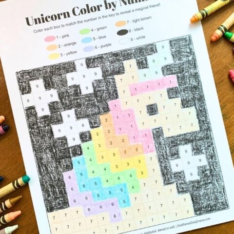 Unicorn color by number with rainbow striped mane and black background.