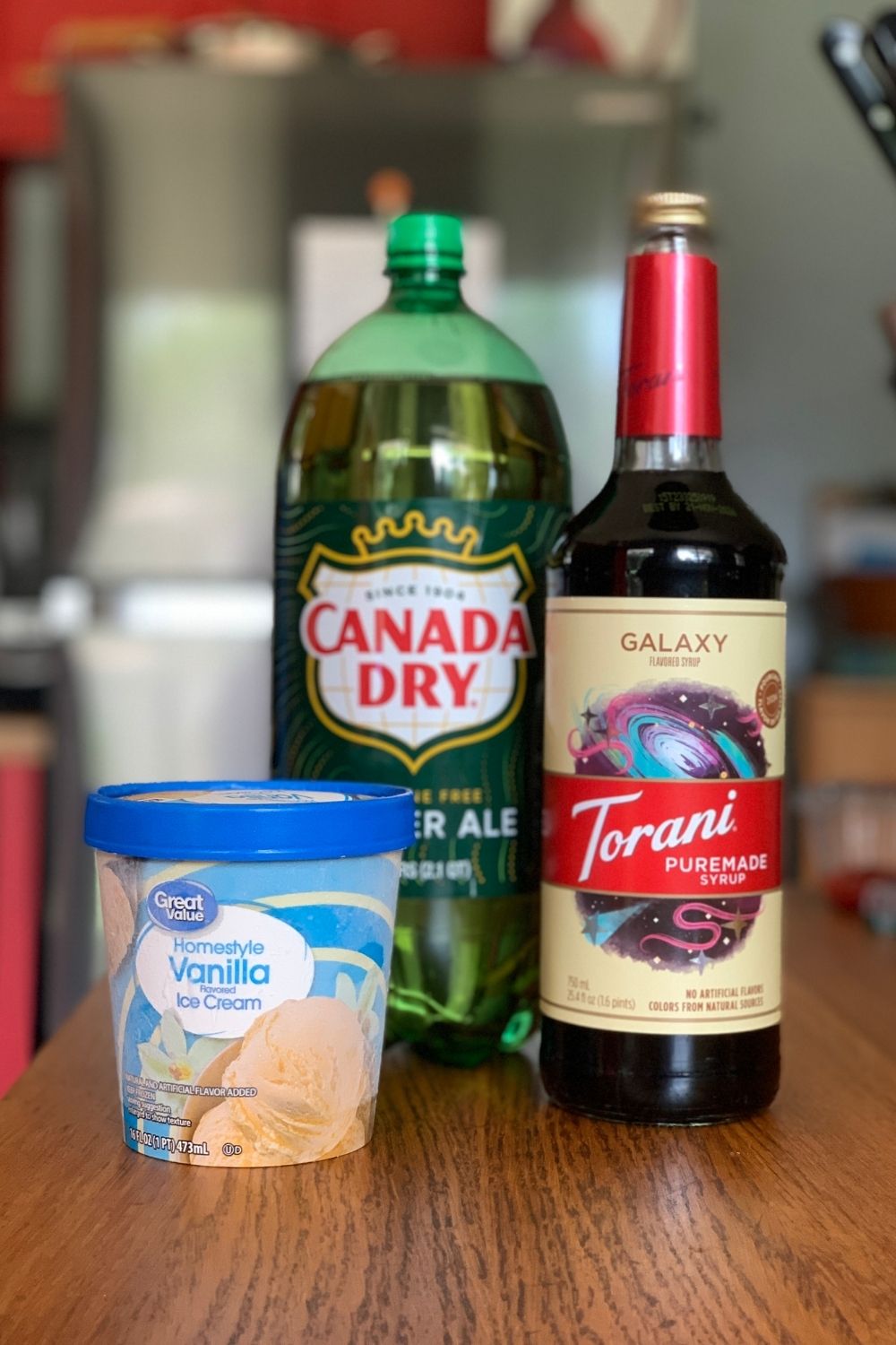 A pint of vanilla ice cream, a 2 liter ginger ale, and a bottle of Torani syrup.