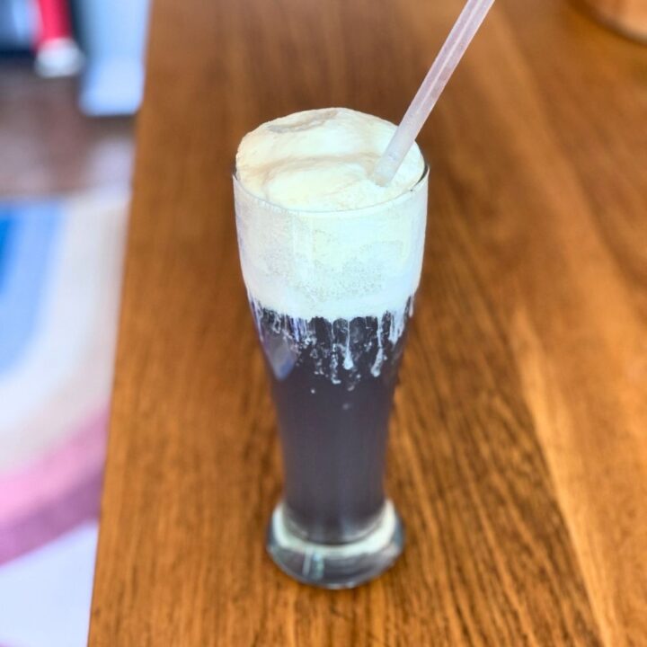 A galaxy drink made with purple soda and vanilla ice cream.