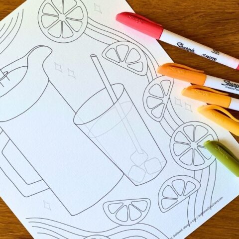 Printable lemonade coloring page with a glass of ice and a straw beside a pitcher, surrounded by sliced lemons and stripes.