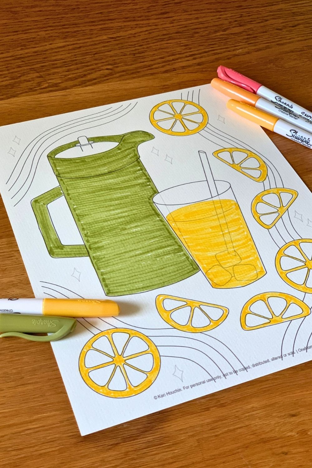 Coloring a picture of lemonade yellow and a pitcher green with markers.